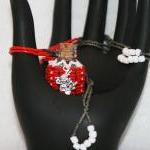 Necklace Beaded Bottle In Red, Gray, And White..